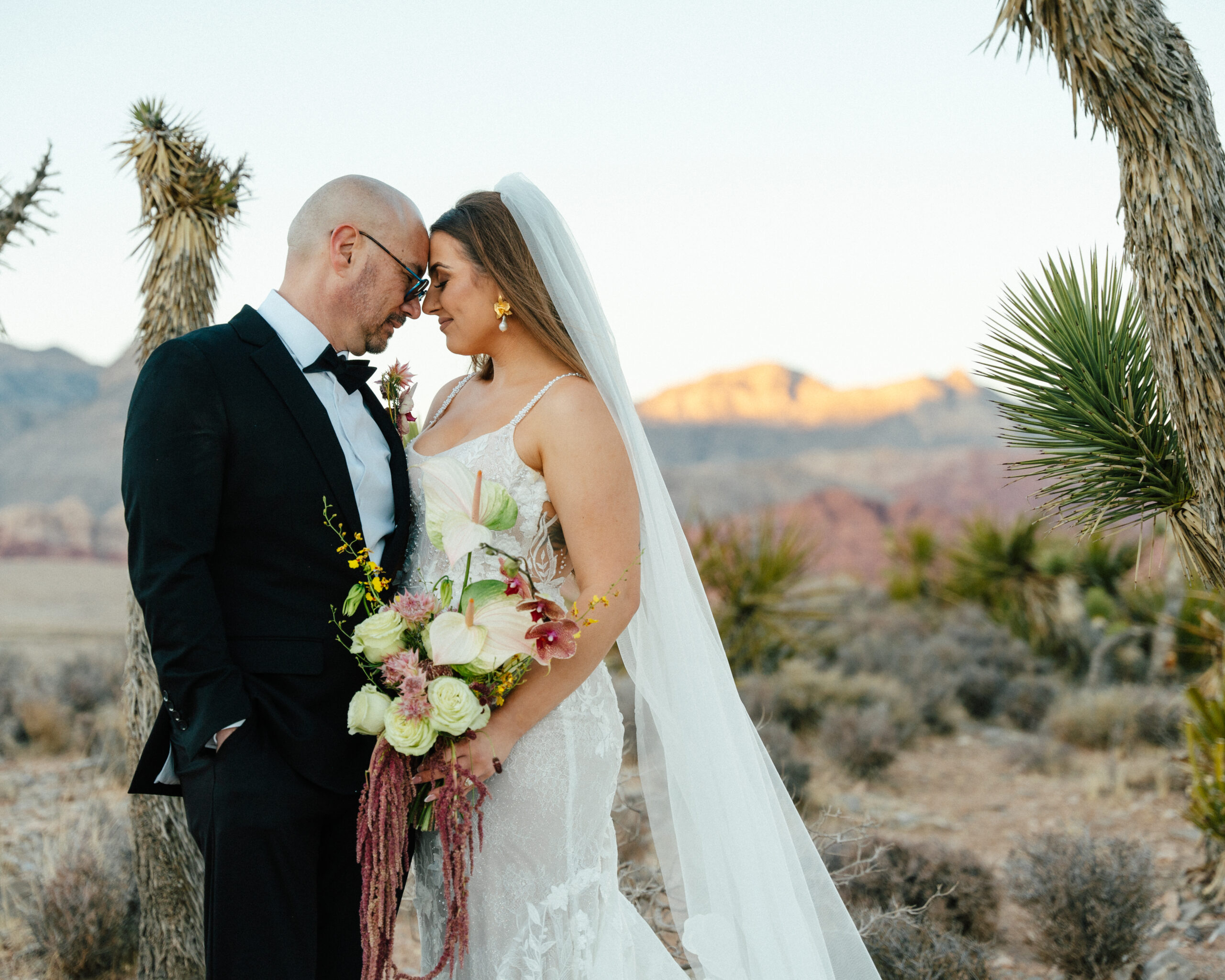 newlyweds share an intimate moment at sunset just after their elopement in red rock canyon