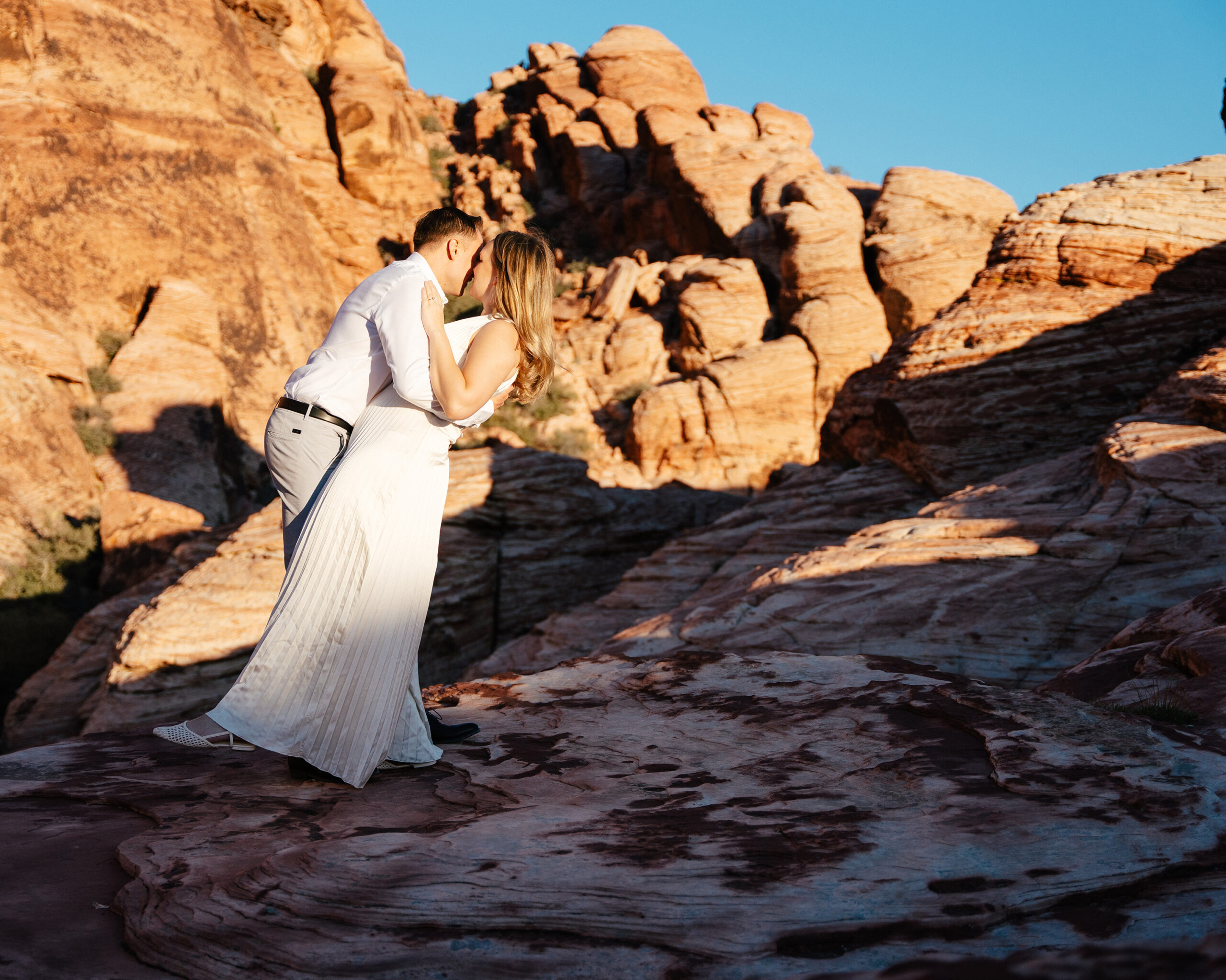 man dips his wife after their elopement in Red Rock Canyon