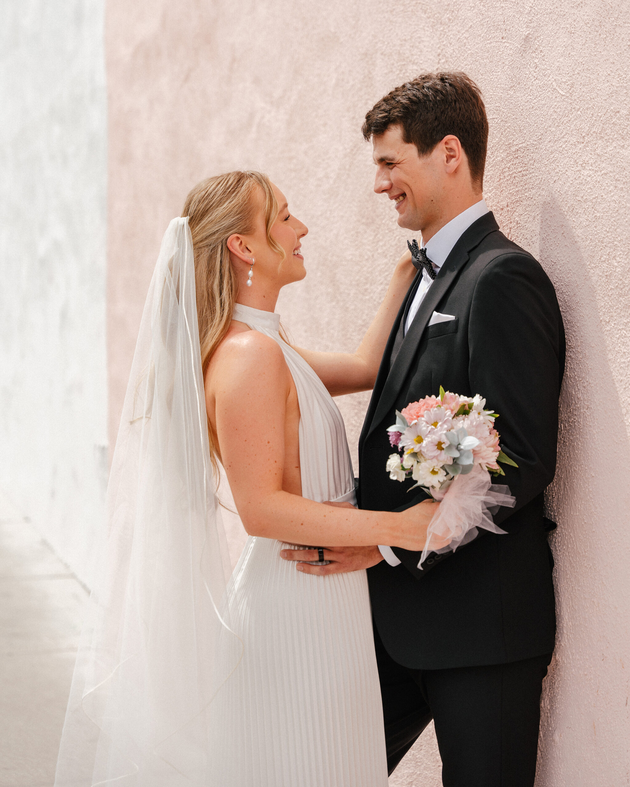 couple shares a moment staring into each other's eyes after getting married at a little white chapel
