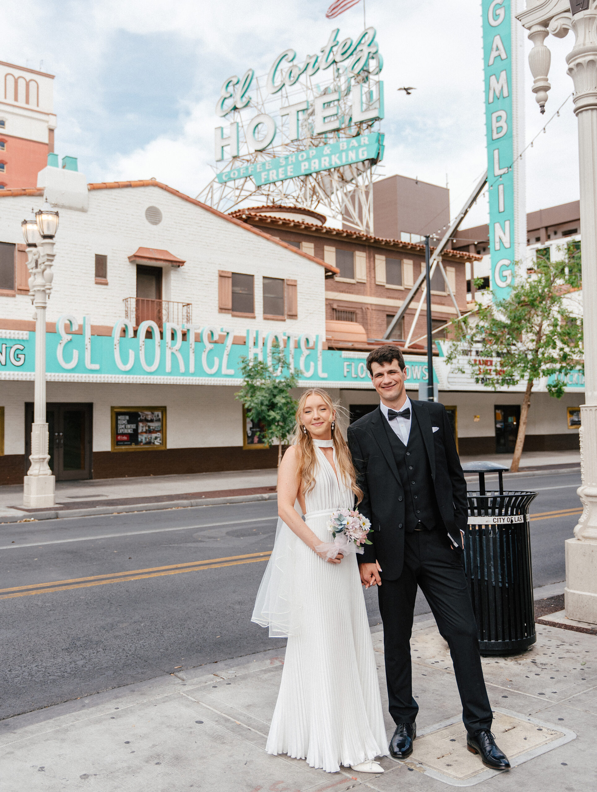 newlyweds taking fremont street portraits on a sunny day after getting married at a little white chapel