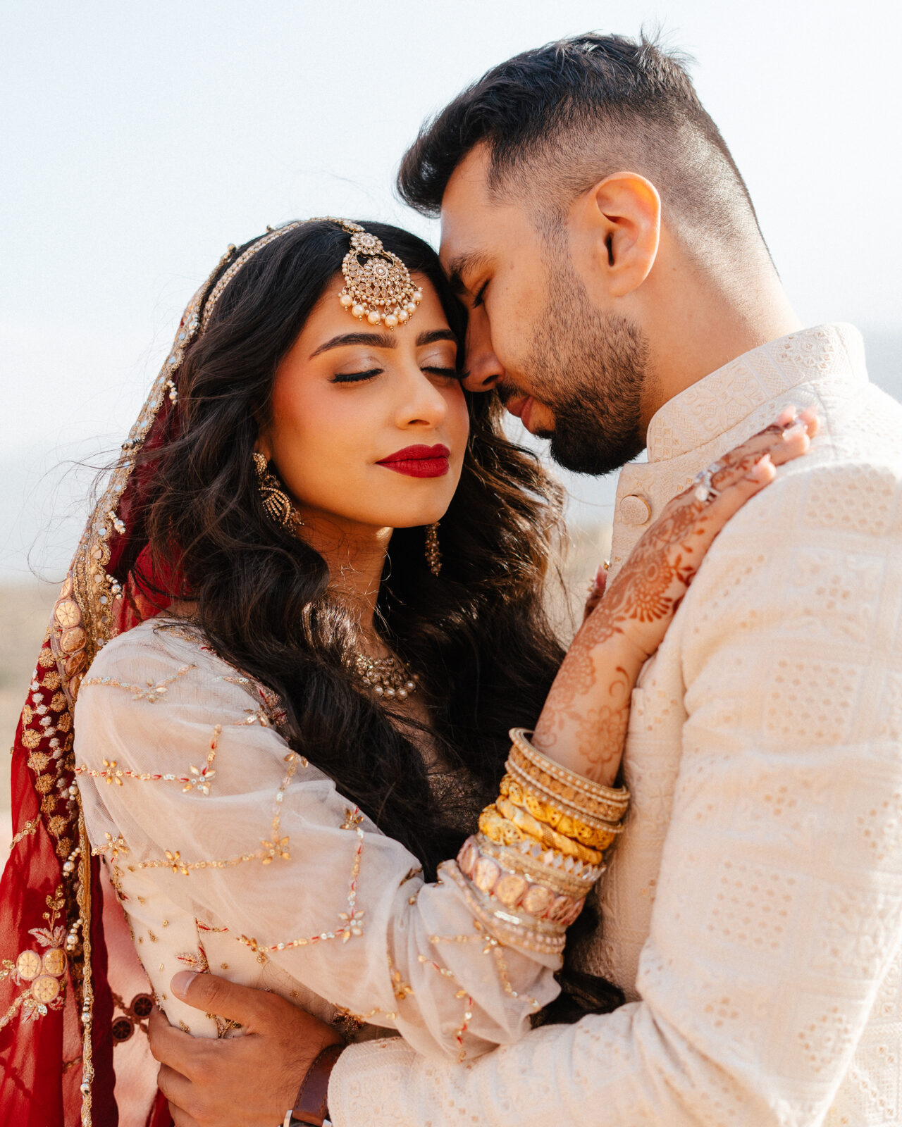 Bride and groom share a quiet moment under the golden light during red rock canyon wedding photos in Las Vegas