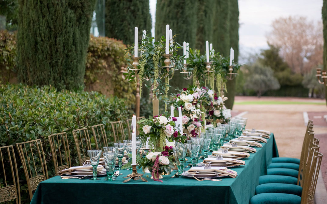 Elegant outdoor wedding reception table at Green Valley Ranch Resort, styled with emerald linens, floral centerpieces, and gold candelabras.