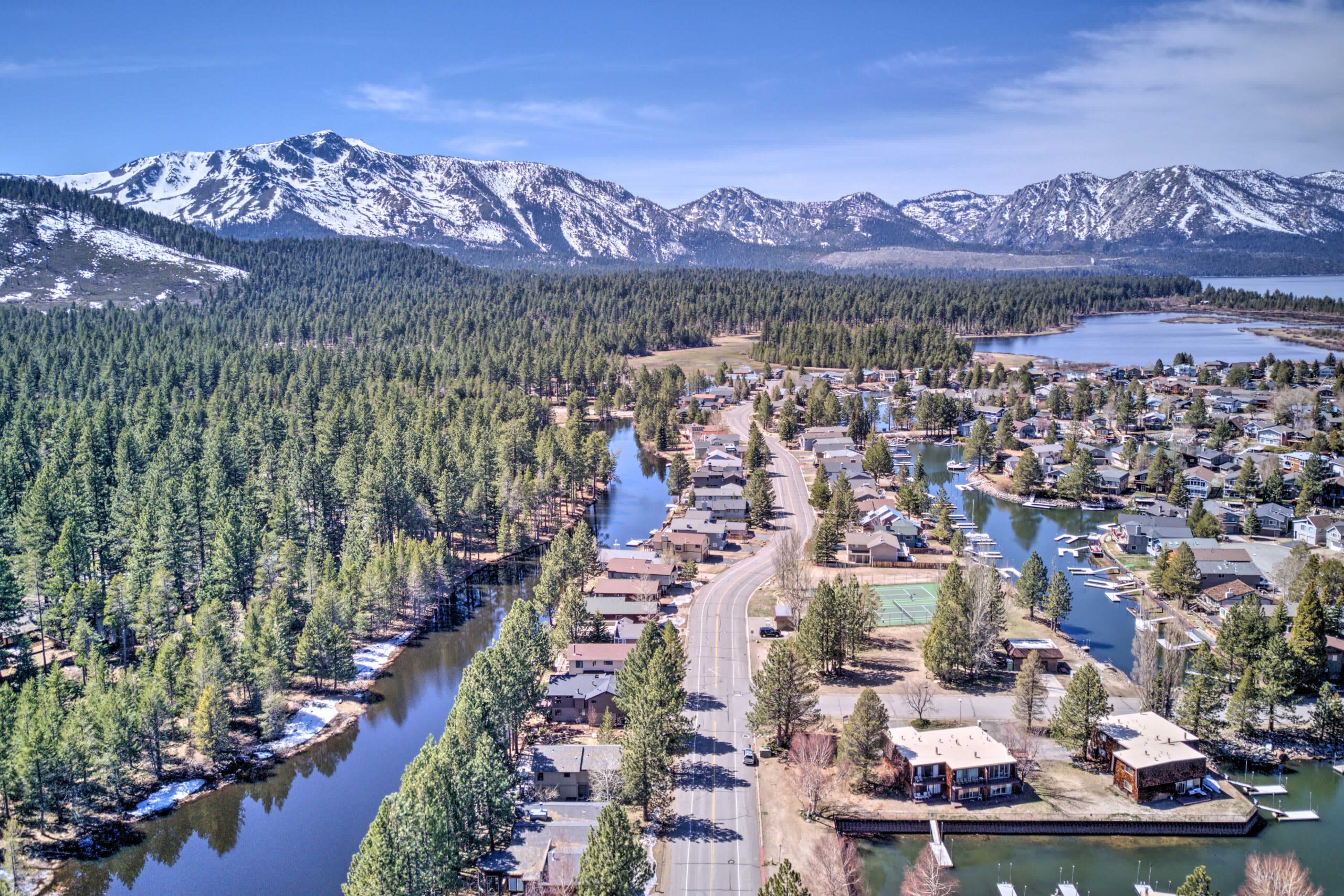 Downtown south lake tahoe as seen from the sky on a beautiful clearn day with snow capped mountains in the background