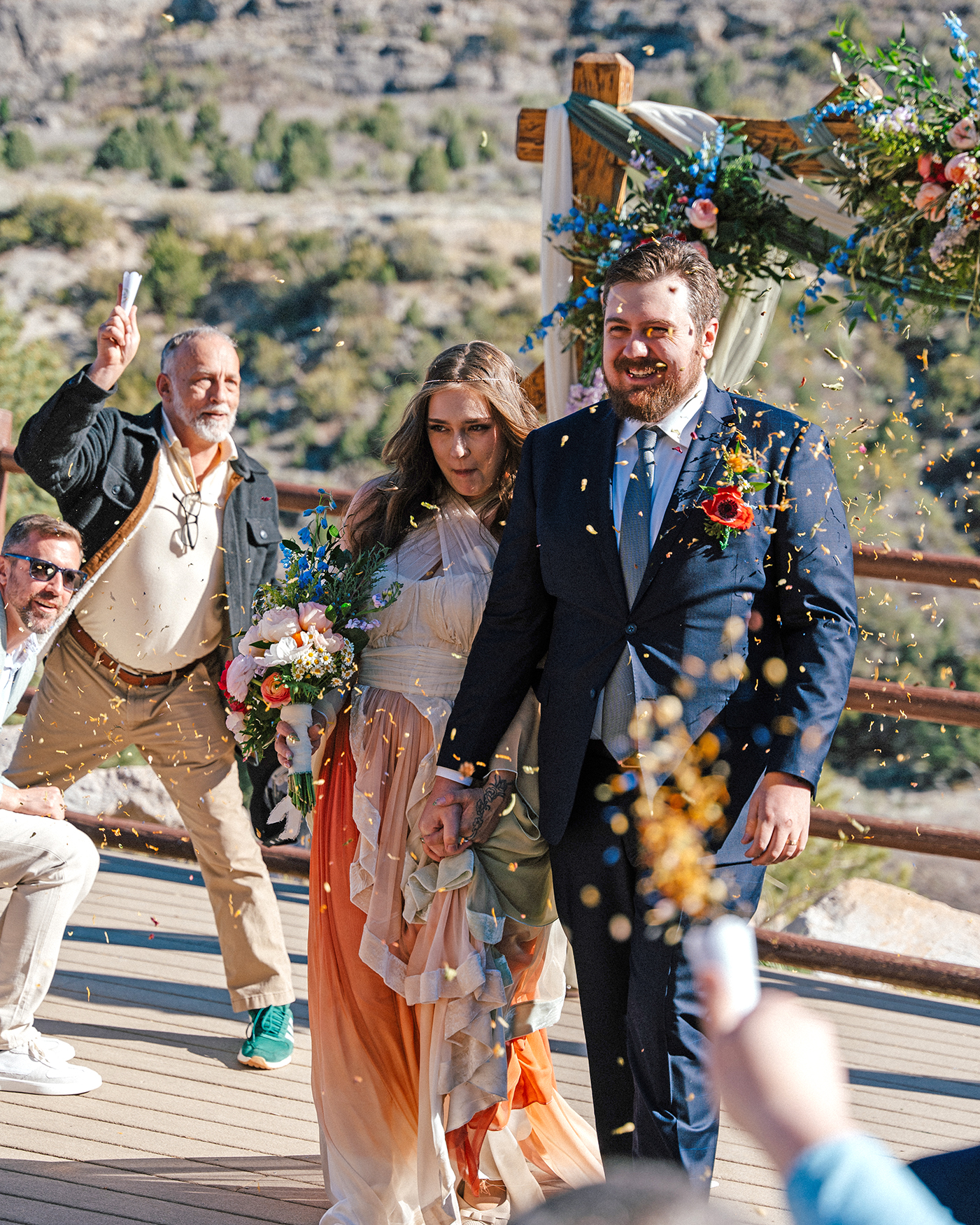Confetti launch as the couple exits the ceremony deck.
