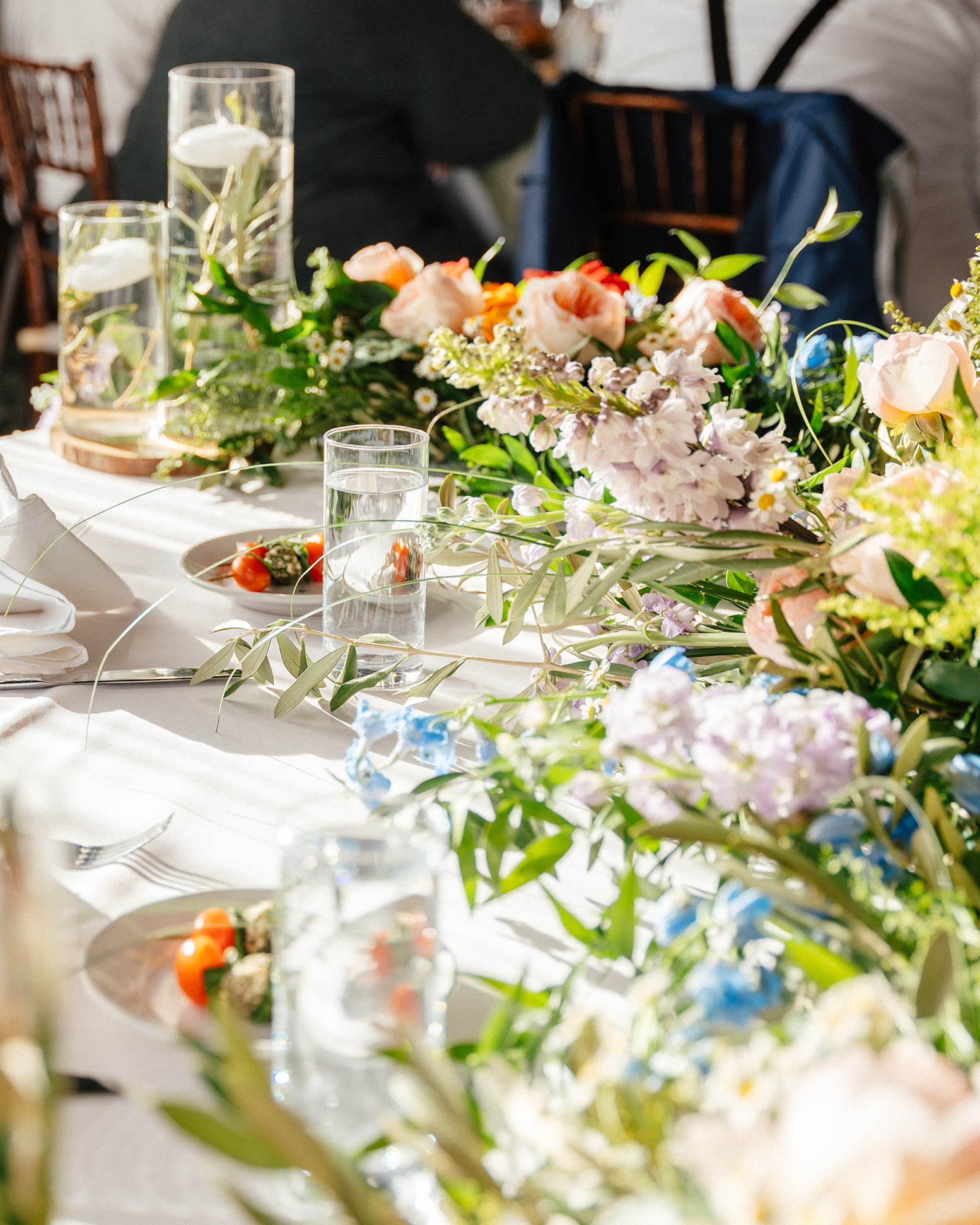 A wedding reception table set with fresh floral arrangements, floating candles, and plated appetizers at a Las Vegas wedding.