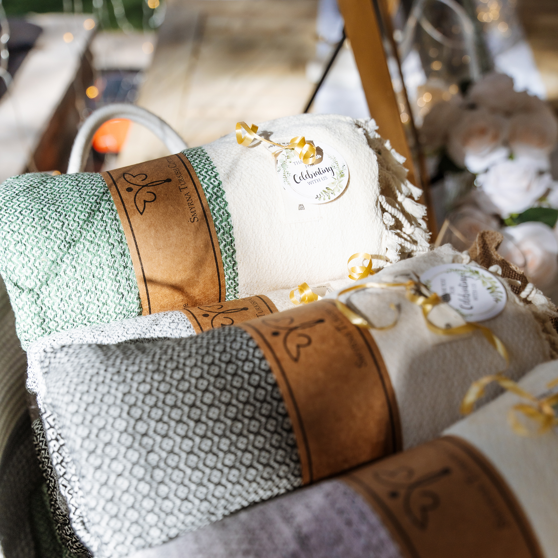Cozy wedding favor blankets wrapped in kraft paper and ribbon, ready for guests at a Las Vegas outdoor wedding celebration.