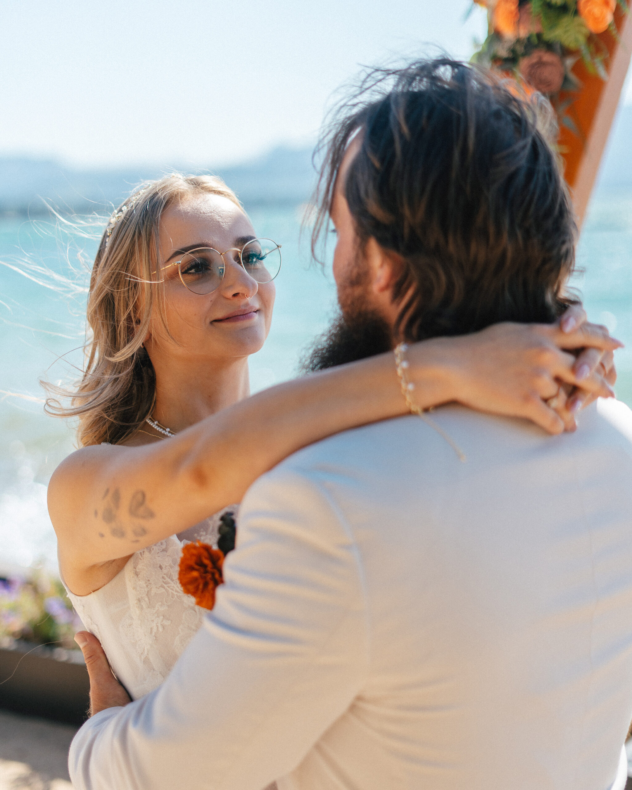 A bride lovingly gazes at her groom during their intimate ceremony by the water in South Lake Tahoe.
