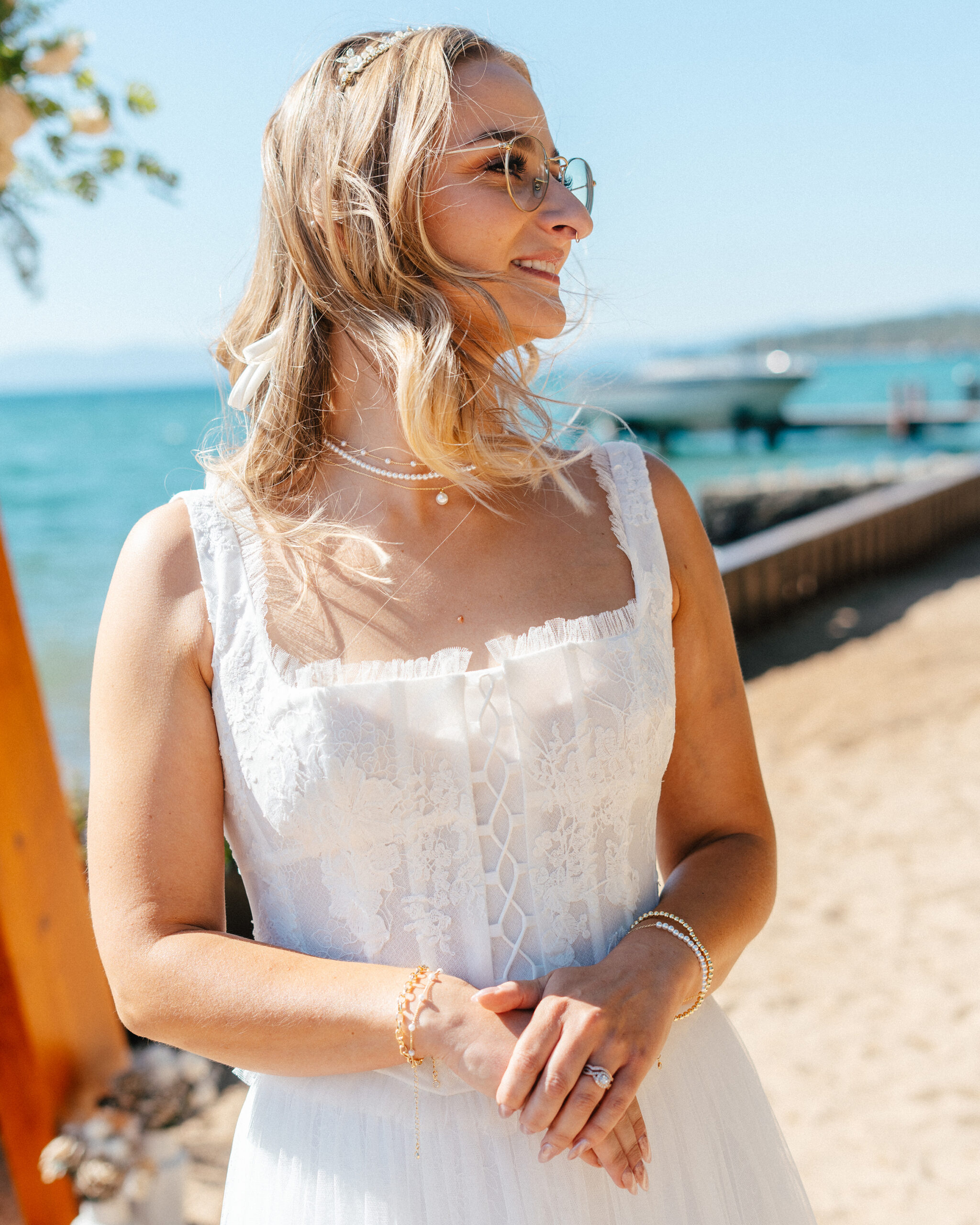 A radiant bride in a boho lace gown celebrates her wedding on the lakefront.