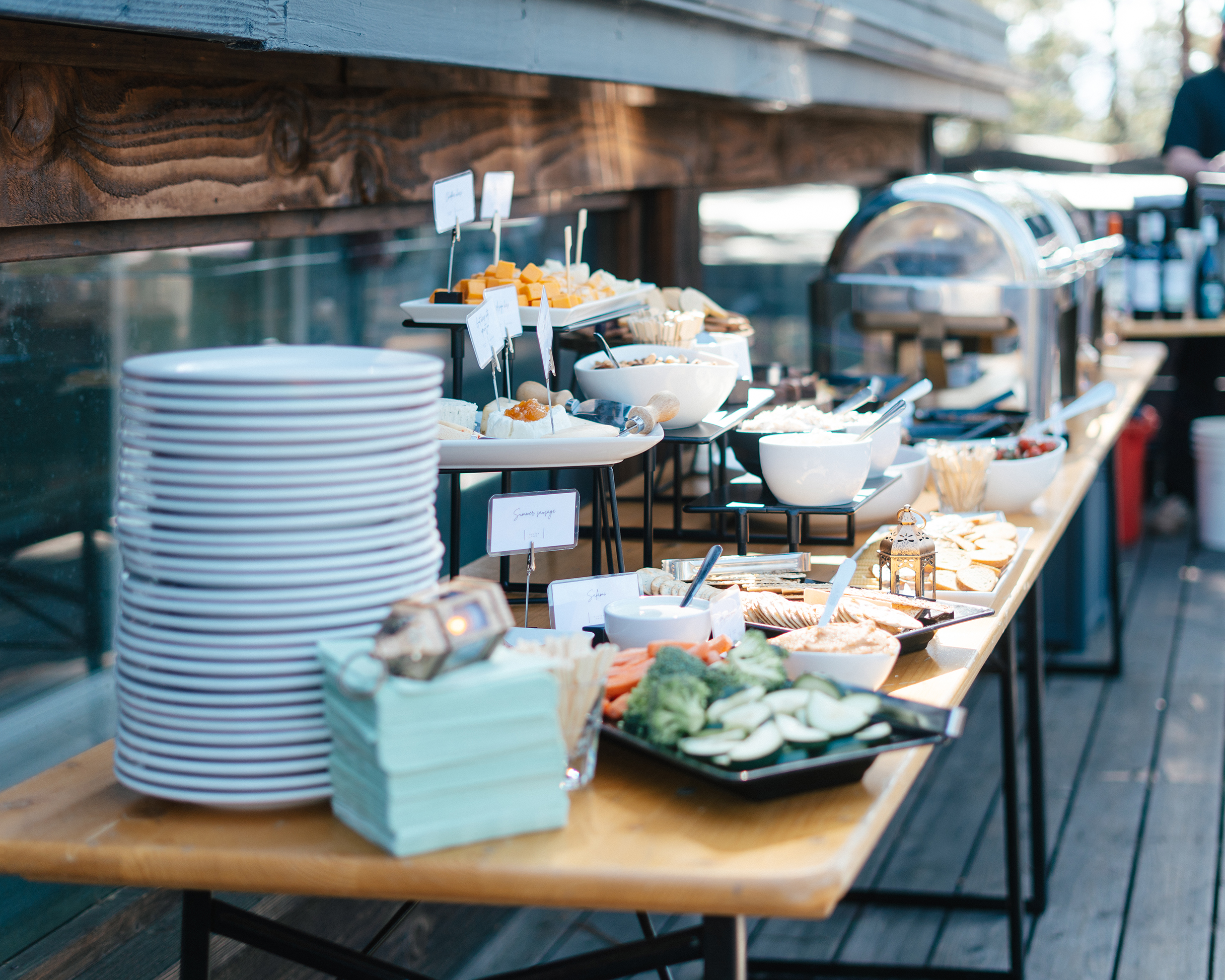 A stylish outdoor wedding buffet in Las Vegas featuring cheese, vegetables, dips, and elegant catering presentation.