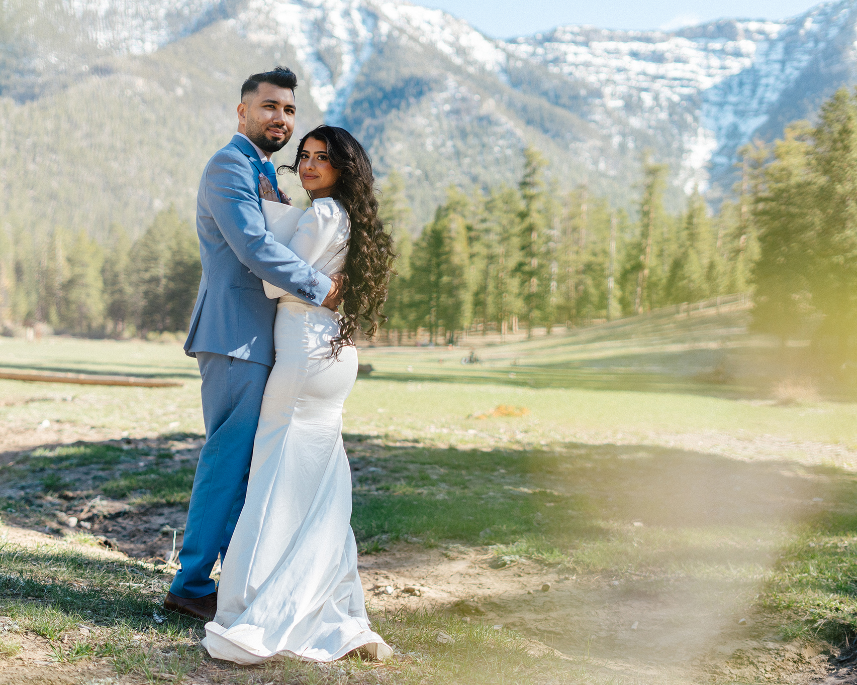 bride and groom holding each other with the beautiful Mt. Charleston in the background